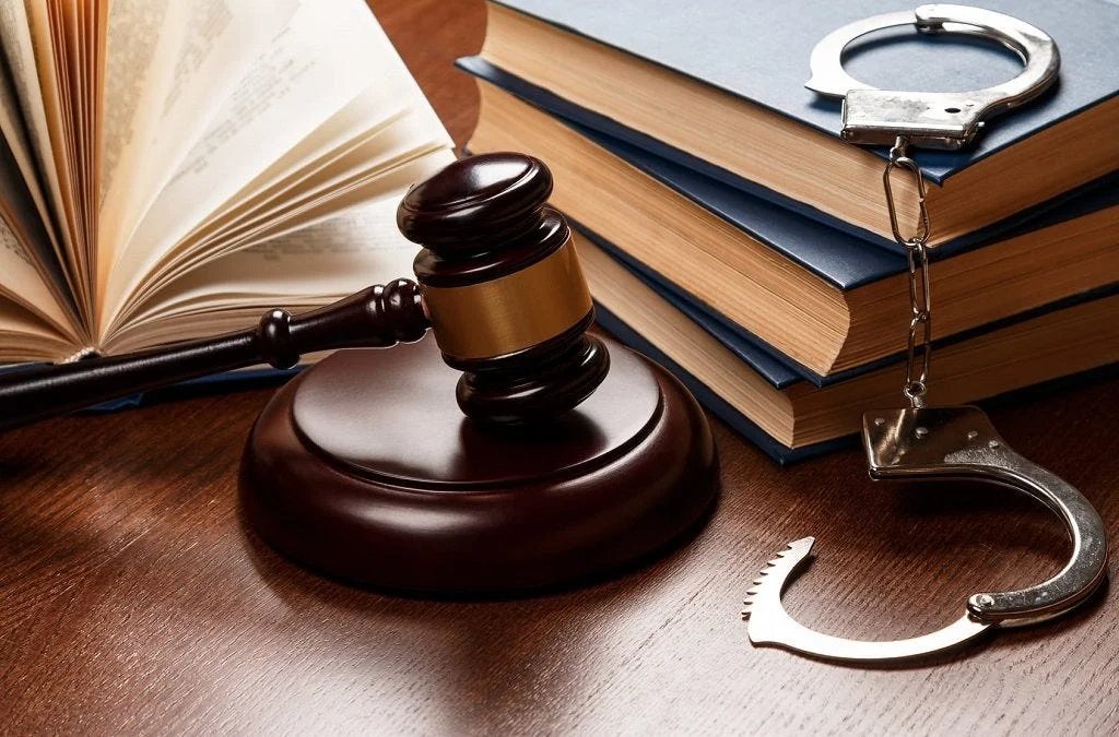Criminal Law Legal Services - Qanoon Group Gavel, law books and handcuffs representing criminal law proceedings in Pakistan